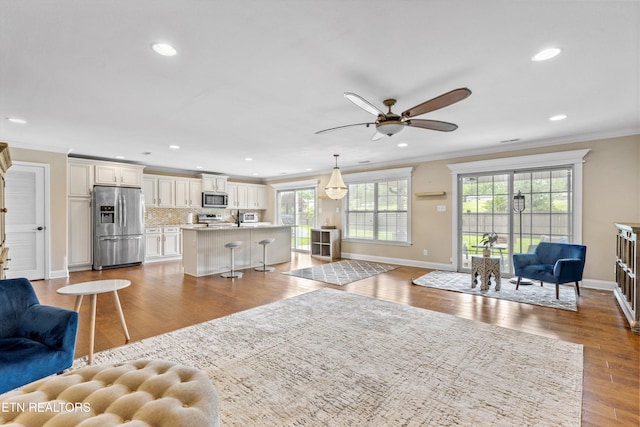 1017 Brighton Dr, Alcoa, TN 37701 - living area featuring ornamental molding, plenty of natural light, recessed lighting, a ceiling fan, and baseboards