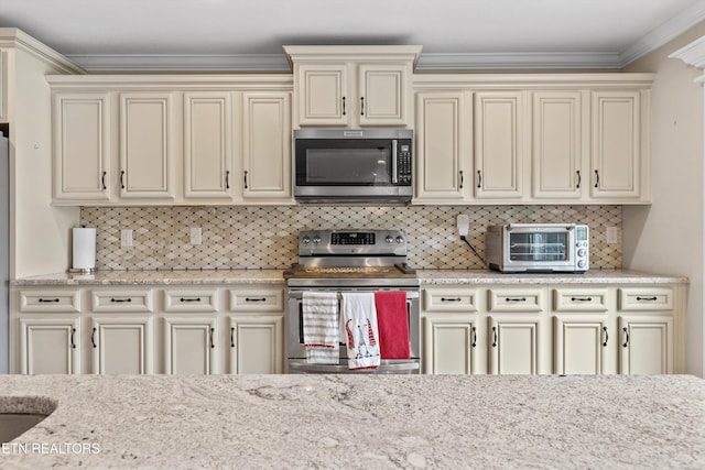1017 Brighton Dr, Alcoa, TN 37701 - kitchen with stainless steel appliances, cream cabinets, crown molding, tasteful backsplash, and light stone counters