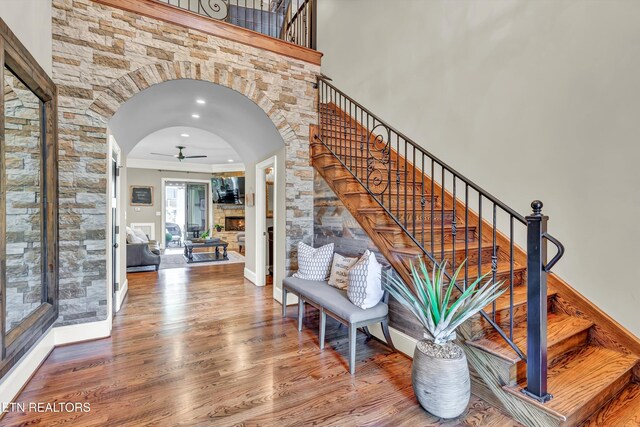 211 Cool Springs Blvd, Knoxville, TN 37934 - stairway with arched walkways, wood finished floors, a ceiling fan, crown molding, and baseboards