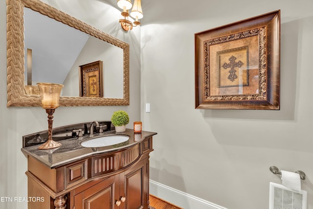 211 Cool Springs Blvd, Knoxville, TN 37934 - bathroom featuring vanity, vaulted ceiling, wood finished floors, and baseboards
