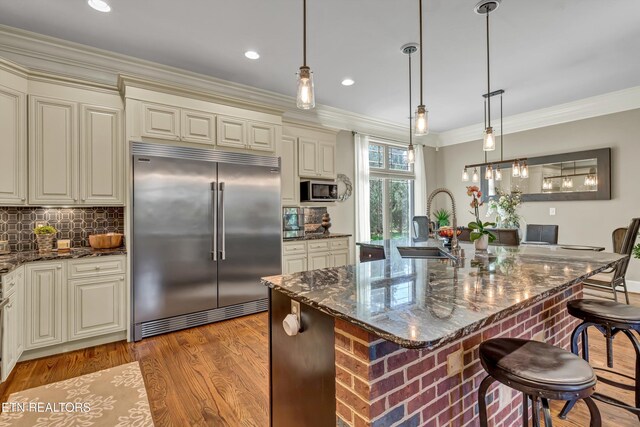 211 Cool Springs Blvd, Knoxville, TN 37934 - kitchen with appliances with stainless steel finishes, a sink, crown molding, backsplash, and cream cabinetry