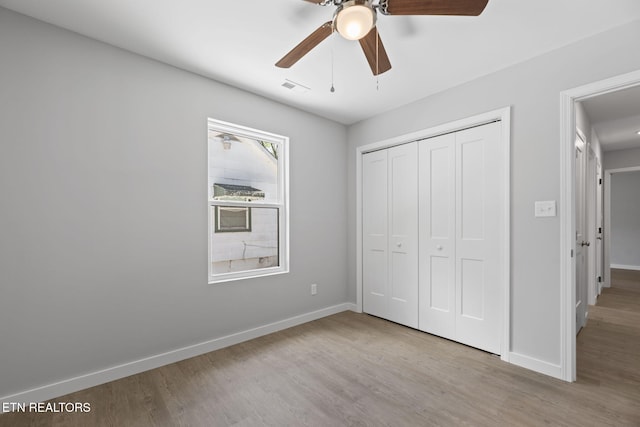 1219 NW Dakota Ave, Knoxville, TN 37921 - unfurnished bedroom with baseboards, wood finished floors, and a closet