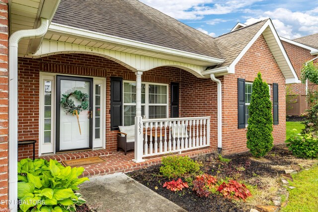 1625 Linden Hall Dr, Alcoa, TN 37701 - view of exterior entry featuring covered porch, roof with shingles, and brick siding