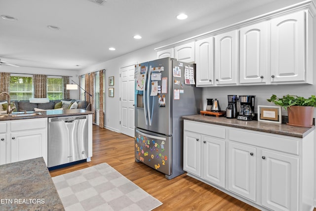 1625 Linden Hall Dr, Alcoa, TN 37701 - kitchen with appliances with stainless steel finishes, dark countertops, light wood-style floors, white cabinets, and recessed lighting