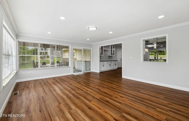 566 Allyson Dr, Kodak, TN 37764 - unfurnished living room featuring crown molding, baseboards, dark wood-style flooring, and recessed lighting