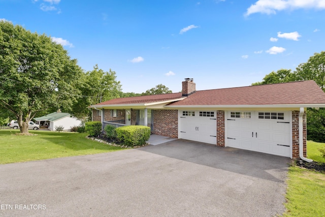 566 Allyson Dr, Kodak, TN 37764 - single story home featuring brick siding, a garage, a front lawn, driveway, and a chimney