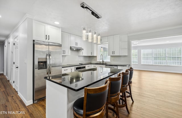 566 Allyson Dr, Kodak, TN 37764 - kitchen featuring appliances with stainless steel finishes, ornamental molding, dark wood-type flooring, dark countertops, and a sink