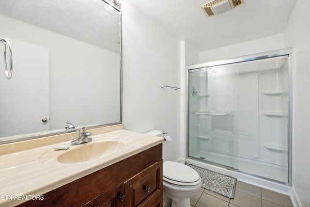 566 Allyson Dr, Kodak, TN 37764 - bathroom with vanity, a shower with shower door, tile patterned floors, and toilet