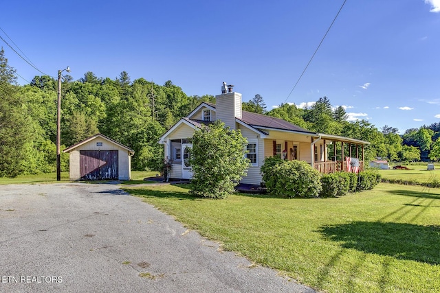 883 Old Harriman Hwy, Harriman, TN 37748 - view of front of property featuring a porch, a garage, a front yard, and a chimney