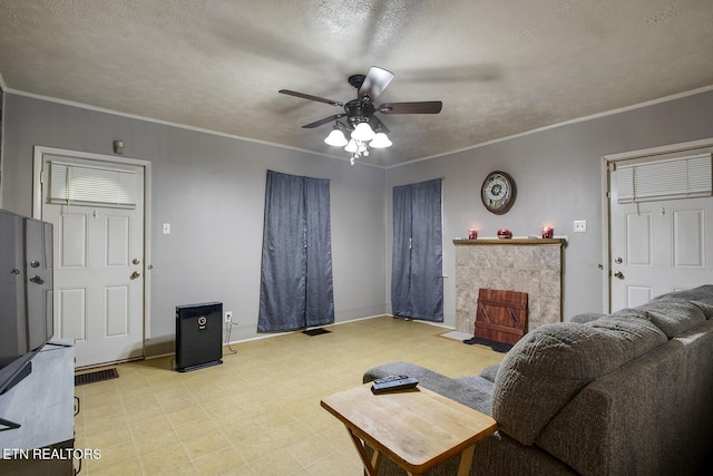 883 Old Harriman Hwy, Harriman, TN 37748 - living area with light flooring, a ceiling fan, baseboards, crown molding, and a tiled fireplace