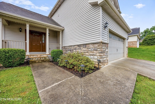 9934 Thunderbolt Way, Knoxville, TN 37923 - entrance to property featuring stone siding, concrete driveway, and a lawn