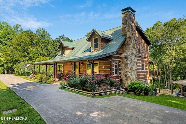 257 Copenhaver Rd, Lenoir City, TN 37771 - view of front of property featuring covered porch, a chimney, and metal roof