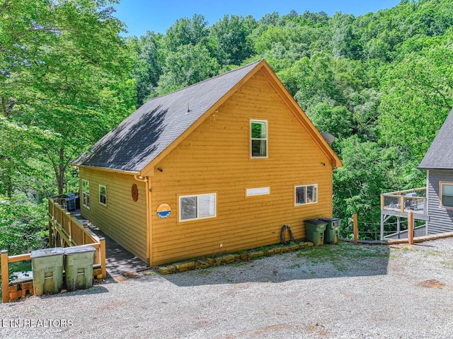 129 Bridgeview Ln, Lafollette, TN 37766 - view of home's exterior with roof with shingles and a wooded view