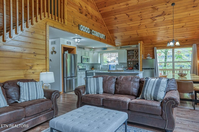 129 Bridgeview Ln, Lafollette, TN 37766 - living room featuring vaulted ceiling, light wood finished floors, and wooden walls