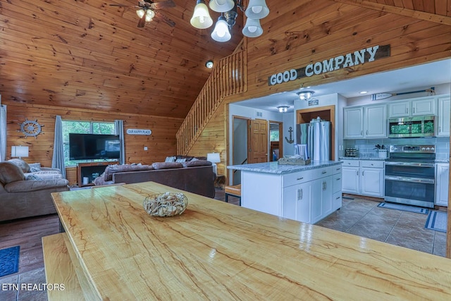 129 Bridgeview Ln, Lafollette, TN 37766 - dining area with wooden walls, a chandelier, and high vaulted ceiling