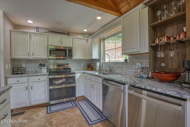 129 Bridgeview Ln, Lafollette, TN 37766 - kitchen with appliances with stainless steel finishes, a sink, tasteful backsplash, and light stone counters