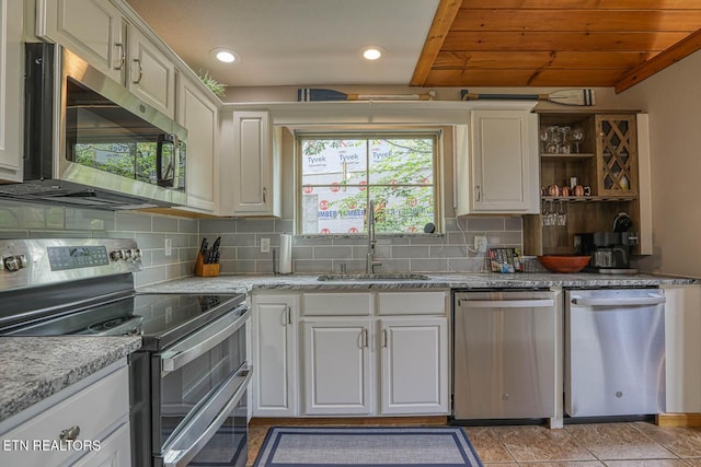 129 Bridgeview Ln, Lafollette, TN 37766 - kitchen with stainless steel appliances, a sink, open shelves, white cabinets, and backsplash