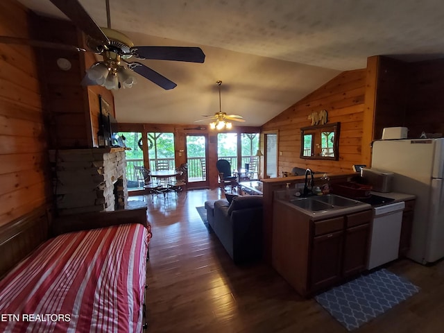 2859 Eagle Crest Way, Sevierville, TN 37876 - kitchen with white appliances, wood walls, a sink, wood finished floors, and vaulted ceiling