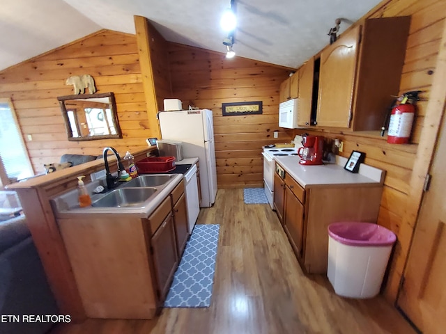 2859 Eagle Crest Way, Sevierville, TN 37876 - kitchen featuring vaulted ceiling, white appliances, a sink, light wood-type flooring, and wooden walls