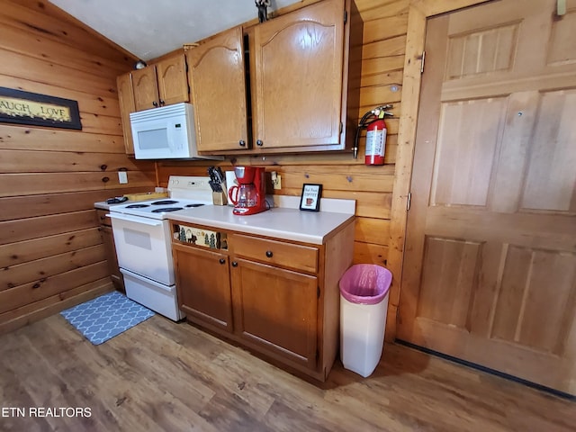 2859 Eagle Crest Way, Sevierville, TN 37876 - kitchen featuring white appliances, light wood-style flooring, wood walls, light countertops, and lofted ceiling