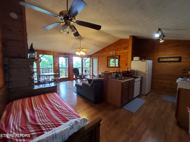 2859 Eagle Crest Way, Sevierville, TN 37876 - living room featuring wood walls, vaulted ceiling, light wood finished floors, and ceiling fan