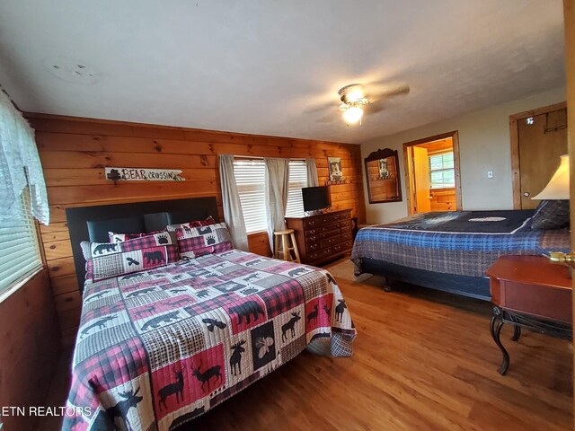 2859 Eagle Crest Way, Sevierville, TN 37876 - bedroom featuring wood finished floors, wood walls, and a ceiling fan