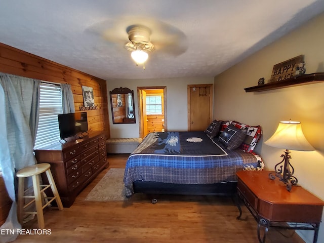 2859 Eagle Crest Way, Sevierville, TN 37876 - bedroom with wood finished floors, multiple windows, wood walls, and a ceiling fan