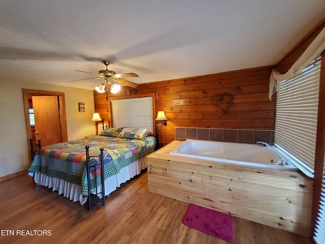 2859 Eagle Crest Way, Sevierville, TN 37876 - bedroom featuring wood finished floors, a ceiling fan, wooden walls, and multiple windows