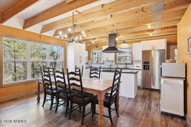 6131 Happy Valley Loop, Tallassee, TN 37878 - dining area with a chandelier, beam ceiling, dark wood-type flooring, and baseboards