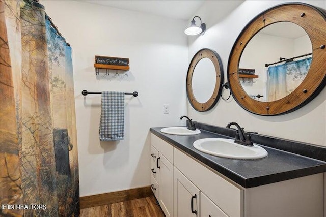 6131 Happy Valley Loop, Tallassee, TN 37878 - bathroom with wood finished floors, double vanity, baseboards, and a shower with shower curtain