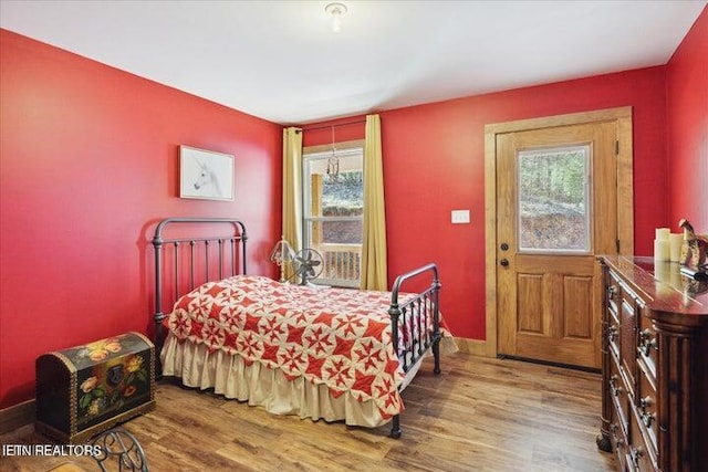 6131 Happy Valley Loop, Tallassee, TN 37878 - bedroom with multiple windows, wood finished floors, and baseboards