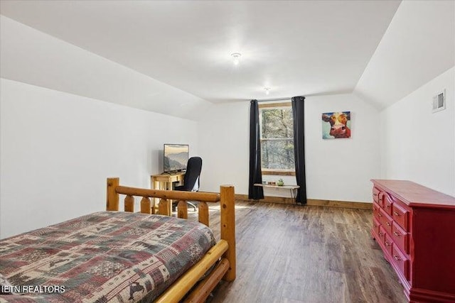 6131 Happy Valley Loop, Tallassee, TN 37878 - bedroom with lofted ceiling, wood finished floors, and baseboards