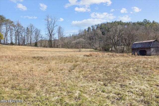 6131 Happy Valley Loop, Tallassee, TN 37878 - view of yard featuring a view of rural / pastoral area, an outdoor structure, and a forest view