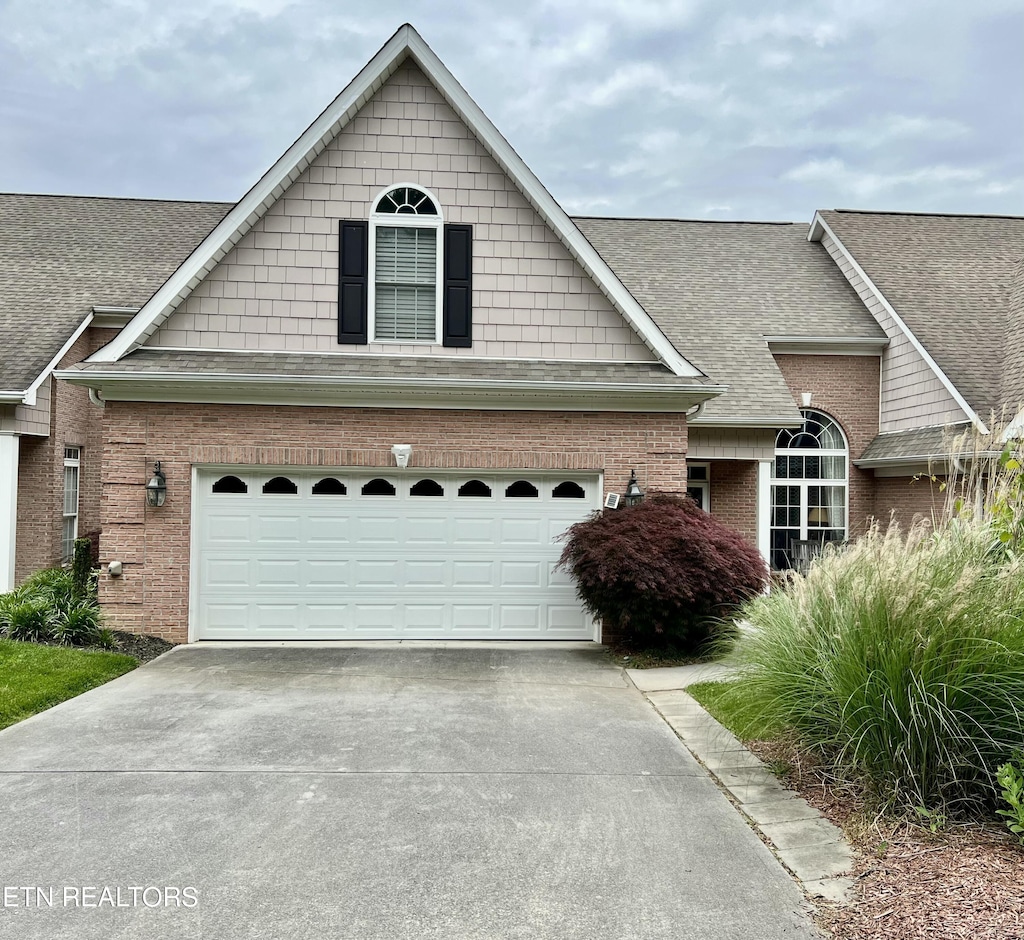 1077 Creekside Village Way, Seymour, TN 37865 - view of front facade with brick siding, driveway, and a shingled roof