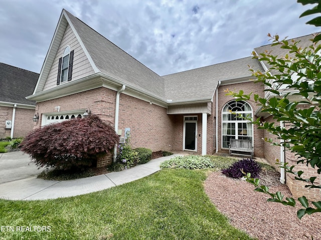 1077 Creekside Village Way, Seymour, TN 37865 - view of front of home with brick siding, an attached garage, roof with shingles, and a front lawn