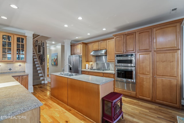 1077 Creekside Village Way, Seymour, TN 37865 - kitchen with appliances with stainless steel finishes, under cabinet range hood, a warming drawer, a sink, and a kitchen island with sink