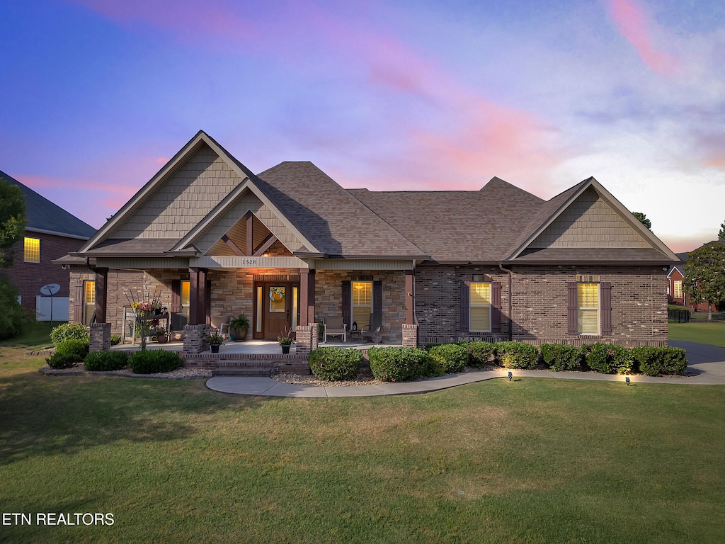 1528 Aberdeen Dr, Alcoa, TN 37701 - craftsman house featuring a porch, a yard, roof with shingles, and stone siding