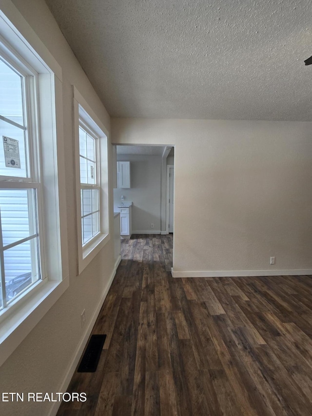678 Skyline Dr, Oneida, TN 37841 - spare room with dark wood-type flooring, a textured ceiling, and baseboards