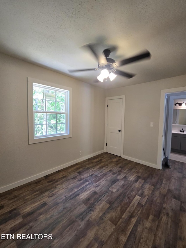678 Skyline Dr, Oneida, TN 37841 - spare room with dark wood-style floors, a ceiling fan, a textured ceiling, and baseboards