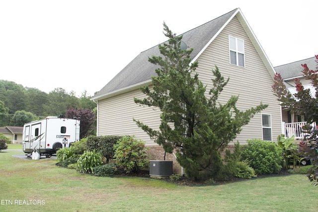 120 Lakeside Dr, Kingston, TN 37763 - view of home's exterior featuring a yard, a shingled roof, and central AC