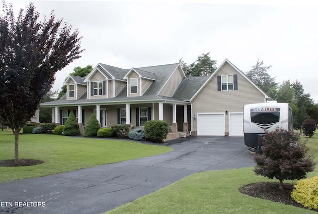 120 Lakeside Dr, Kingston, TN 37763 - cape cod-style house featuring asphalt driveway, a porch, a garage, and a front lawn