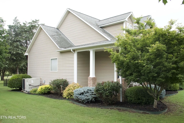 120 Lakeside Dr, Kingston, TN 37763 - view of side of property featuring a yard, a shingled roof, and central AC