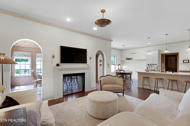 2811 Pleasant View Ave, Maryville, TN 37803 - living area with healthy amount of natural light, ornamental molding, arched walkways, a fireplace, and wood finished floors