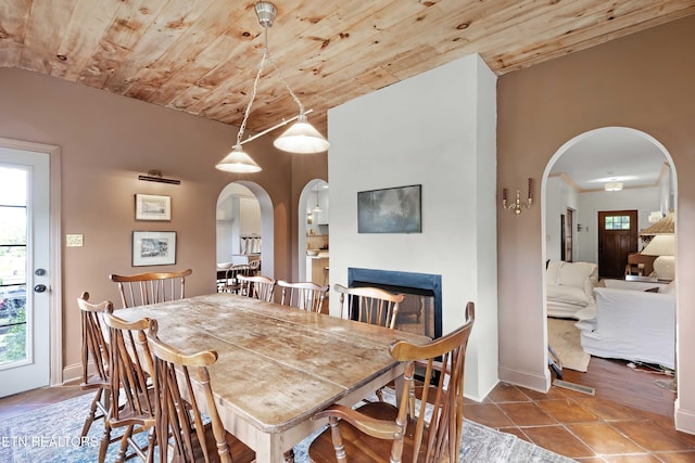 2811 Pleasant View Ave, Maryville, TN 37803 - dining space featuring arched walkways, wooden ceiling, tile patterned flooring, a fireplace, and baseboards