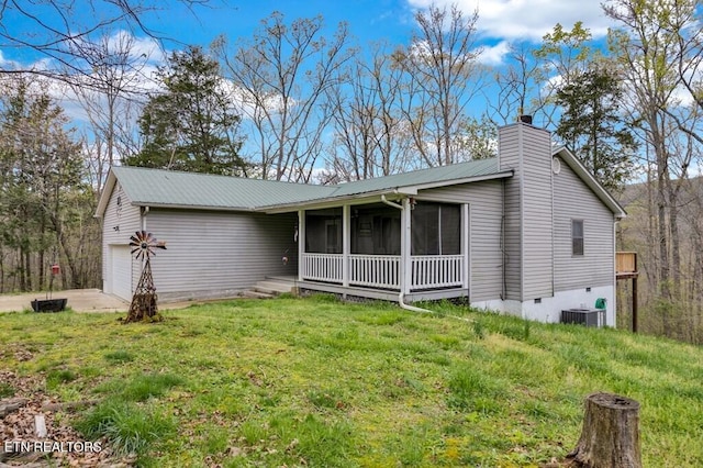 108 W Bobcat Ln, Wilder, TN 38589 - view of front facade with a garage, a sunroom, metal roof, central AC unit, and a chimney