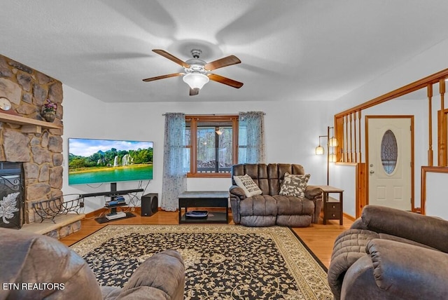 108 W Bobcat Ln, Wilder, TN 38589 - living room featuring wood finished floors, a ceiling fan, and a stone fireplace
