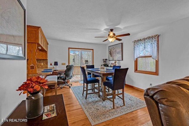 108 W Bobcat Ln, Wilder, TN 38589 - dining space featuring ceiling fan, light wood-style floors, and baseboards