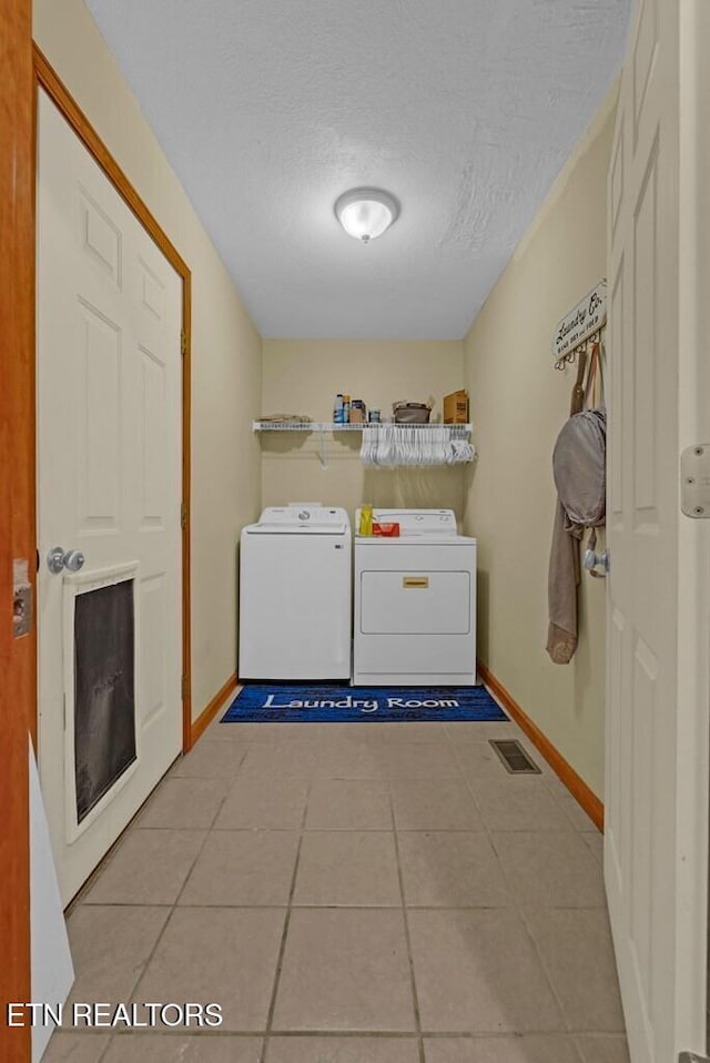 108 W Bobcat Ln, Wilder, TN 38589 - washroom featuring independent washer and dryer, baseboards, light tile patterned flooring, and a textured ceiling