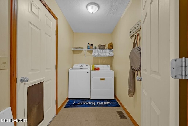 108 W Bobcat Ln, Wilder, TN 38589 - laundry room featuring baseboards, washer and clothes dryer, and a textured ceiling