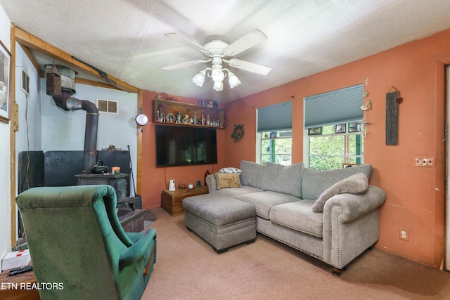 4349 Locust Ridge Rd, Sevierville, TN 37876 - carpeted living room with a wood stove, a ceiling fan, and a textured ceiling